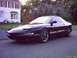 1997 Ford Probe - A 1997 Ford Probe is parked on a street in front of a residential house.