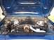 1998 Ford Crown Victoria - The engine bay of a blue 1998 Ford Crown Victoria is shown with the hood open.