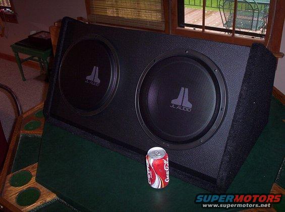 JL Audio dual subwoofer enclosure with a Coca-Cola can for scale
