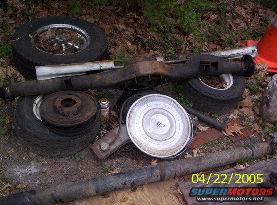 Rear axle assembly and tires with a spray can and air cleaner