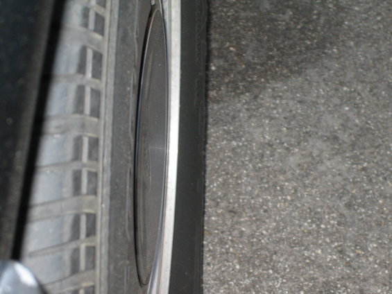 Close-up of a car wheel and tire on asphalt