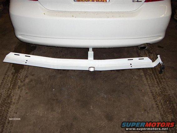 white car rear bumper with trailer hitch receiver installed