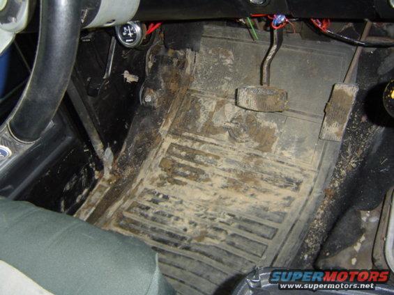 mud on floor mats and pedals inside a vehicle