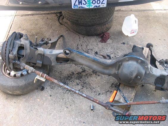 Front axle assembly with steering linkage and brake components