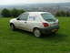 2001 Ford Fiesta - This white Ford van, likely a Fiesta, is parked on a grassy hill with a town in the background.
