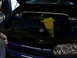 1998 Volkswagen Jetta - The engine bay of a blue 1998 Volkswagen Jetta is shown with a yellow funnel in place.