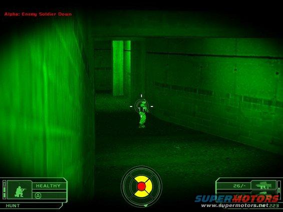 Video game scene in night vision mode showing a hallway with a soldier target and HUD elements