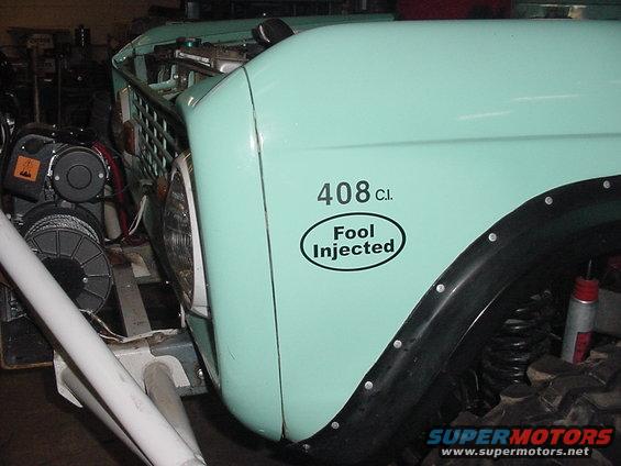 Mint green vehicle fender with '408 C.I. Fool Injected' sticker