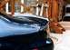 1999 Ford Taurus - Close-up of a car's rear spoiler, showing a water droplet on its surface.