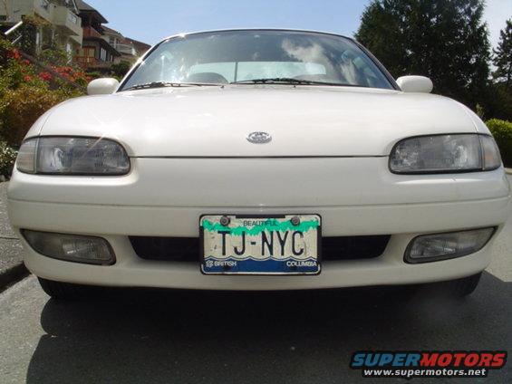 White coupe front view with TJ-NYC license plate