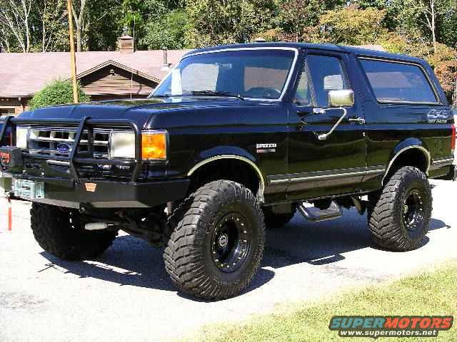 Black lifted SUV with off-road tires, 3/4 front view