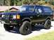 1978 Ford Bronco - This lifted SUV features large off-road tires and a prominent front brush guard.