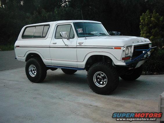 White Ford Bronco with aftermarket bumper and lifted suspension