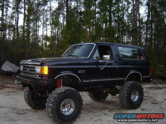 Black lifted Ford Bronco with large tires, seen from a 3/4 front angle