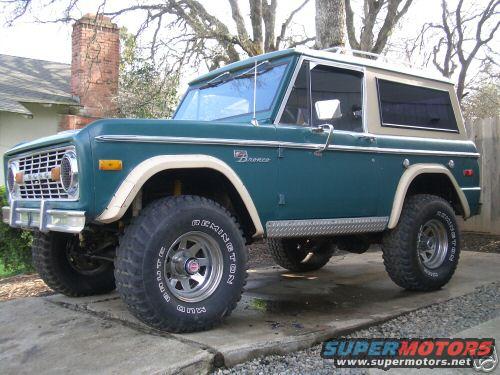 Teal and tan 1978 Ford Bronco SUV, 3q-front view. Tires read 'Remington'