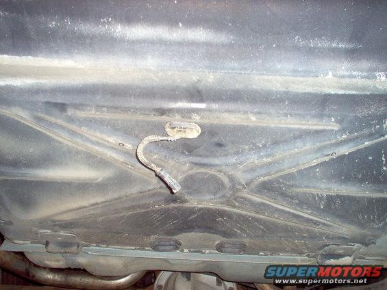 trunk03.jpg I'm using Right Stuff sealant to hold the grommet in place & sealed.  The 2 circles on the ribs are where the canister tray rear bolts will go.