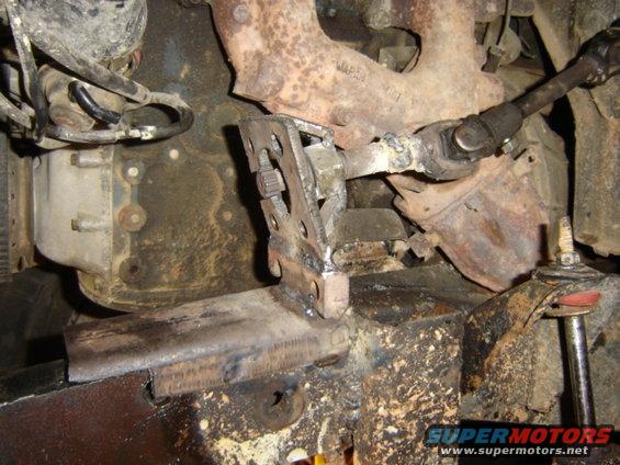 Modified steering linkage and exhaust manifold on a vehicle