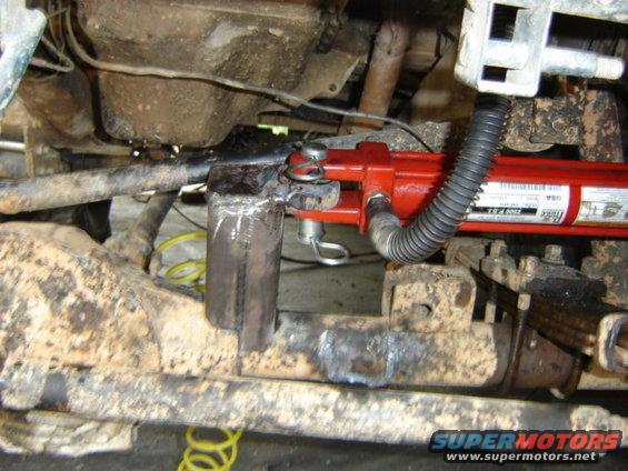 Hydraulic ram attached to a vehicle's suspension linkage