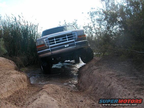 Brown 1992 Ford F-150 navigating muddy terrain