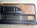 1979 Ford Bronco - This is a door panel with woodgrain insert and chrome trim, likely from a vintage vehicle.