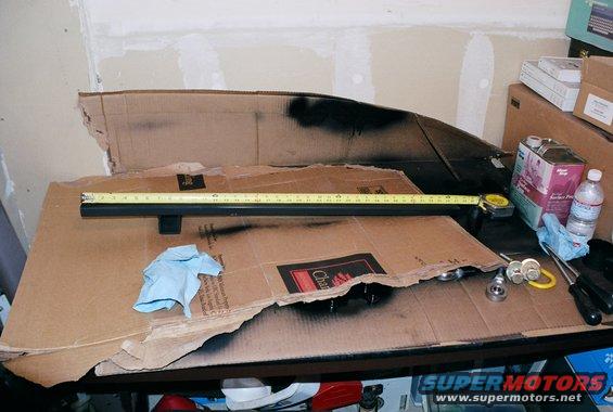 pic-of-shackle-mount-37-inches-by-2x3-inch-11-.jpg Picture of shackle mount while I was painting it.  It is 37" long, 2"x 3" 11 gauge rectangle tube.  There is a peice of 2"x2" square tube welded to it at 7" from left (driver side) to mount the actuall shackle.  This peice mounts in the "drop" on the frame just behind the t-case.  I used the holes from the annoying metal spikes that ford installes.