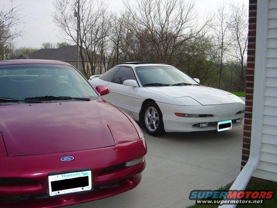 White 1993 Ford Probe parked next to a red one