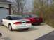 1993 Ford Probe - Two Ford Probes, one white and one red, are parked side-by-side in a driveway.