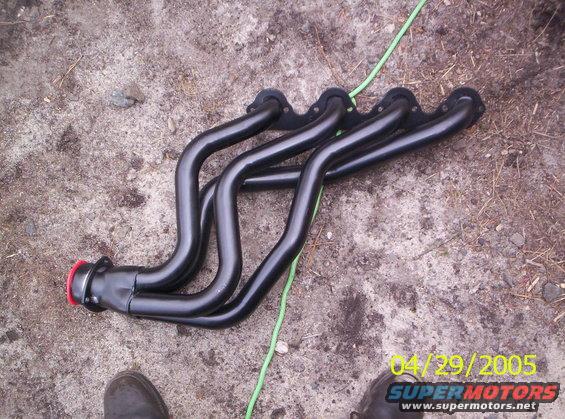 Black exhaust headers on the ground. Date stamp says 04/29/2005