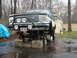1994 Ford Bronco - This 1994 Ford Bronco is elevated on jack stands, revealing its undercarriage and suspension components.