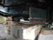 1994 Ford Bronco - Close-up view of a vehicle's undercarriage, with the frame elevated on blocks.