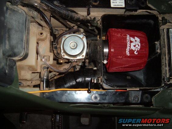 Engine compartment showing a K&N PreCharger air filter attached to a carburetor