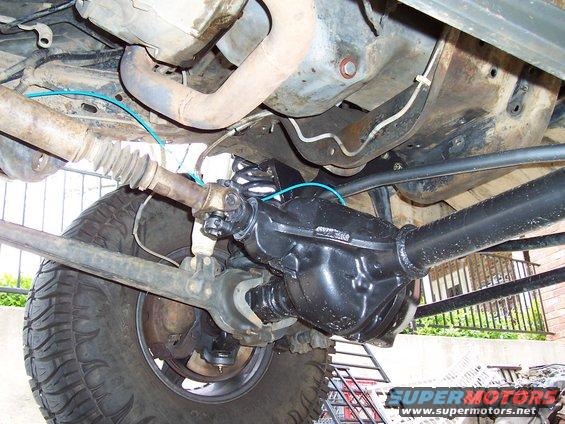 Front axle and suspension parts with driveshaft and tire