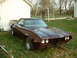 1972 Ford Ranchero - This 1972 Ford Ranchero is parked outside next to a white building.
