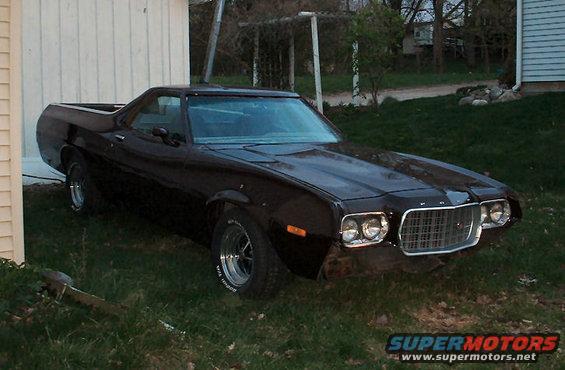 1972 Ford Ranchero parked on grass next to a white building