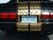1978 Ford Mustang II - Customized rear of a black car gold scale graphics and racing stripes, with an Ontario license plate.