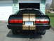 1978 Ford Mustang II - This black car features distinctive gold scale-patterned stripes and a personalized Ontario license plate reading 'ATTITUDE'.