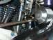 1976 Harley-Davidson Super Glide - Close-up view of motorcycle engine components, including black cylinders and a chrome housing.