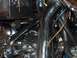 1976 Harley-Davidson Super Glide - Motorcycle engine detail showing chrome pipes and wiring, with 'SUPERMOTORS.NET' watermark.