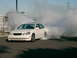 1999 Mercury Grand Marquis - A white Lexus GS sedan is performing a burnout, creating a large cloud of smoke.