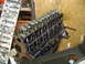 1985 Ford Bronco - Engine block and valve train assembly shown in a workshop setting.