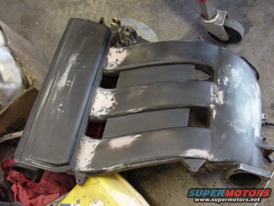 gray intake manifold with multiple runners, some areas sanded