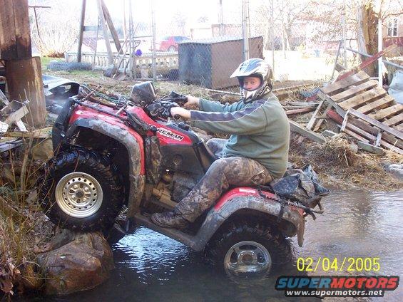 100_2181.jpg me playing in the creek behind my house, its my 4wheelers bathtub