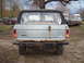 1979 Ford Bronco - This 1978 Ford Bronco is seen from the rear, with other vehicles in a yard.