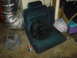 1986 Ford Mustang - A car seat is shown with a fan placed on it, alongside other automotive parts and supplies.