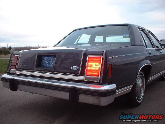 Dark 1984 Ford Crown Victoria LTD rear view with illuminated taillight