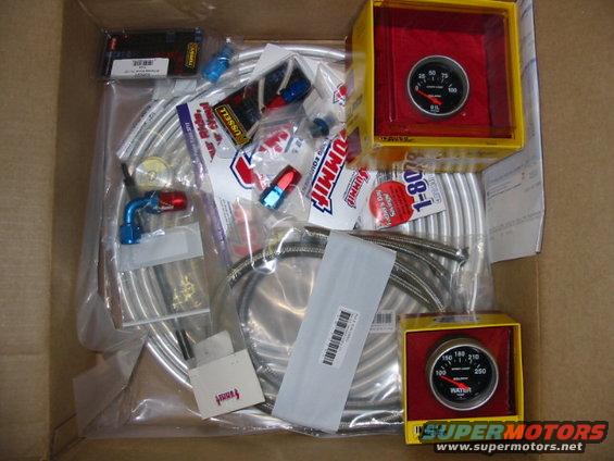 Box of assorted Summit Racing parts including fuel lines, fittings, and two gauges