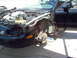 1999 Ford Taurus - Car undergoing repairs, with front end disassembled and engine exposed.