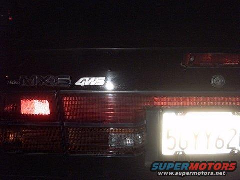 Rear of a Mazda MX-6 with 4WS badging. License plate is visible