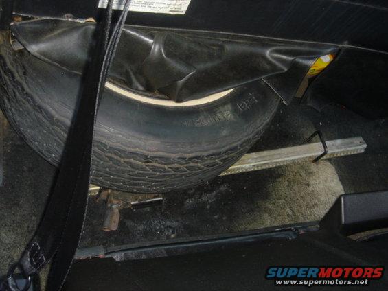 Spare tire and jack stowed in vehicle cargo area