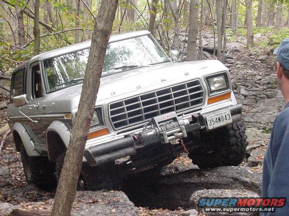 1978 Ford Bronco navigating a rocky trail with a winch mounted on the front bumper